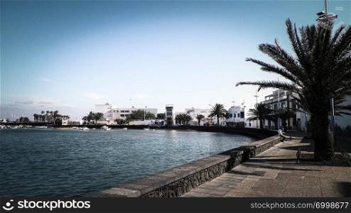 View of El Charco de San Gines, the beautiful marina in Arrecife City. Canarian Architecture, and it’s tropical nature.. View of El Charco de San Gines, Lanzarote island.