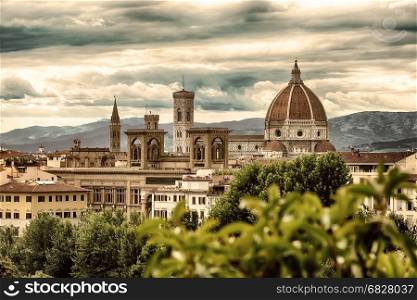 View of famous cathedral Santa Maria del Fiore in Florence and mountains behind it, Italy