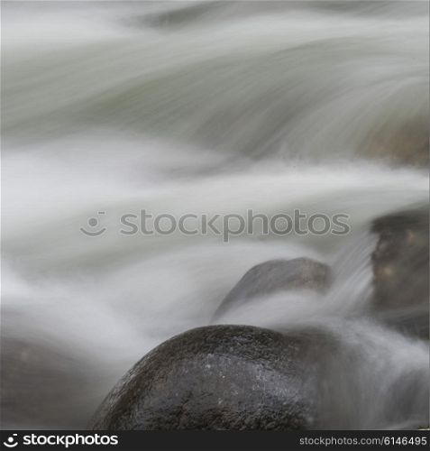 View of fast moving water over rocks in river, Whistler, British Columbia, Canada