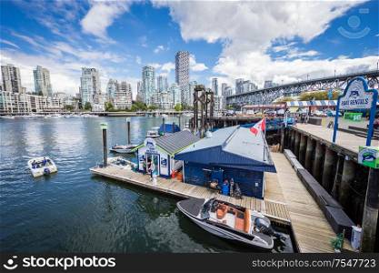View of Ferry Dock at Granville Island with Vancouver Skyline in the back