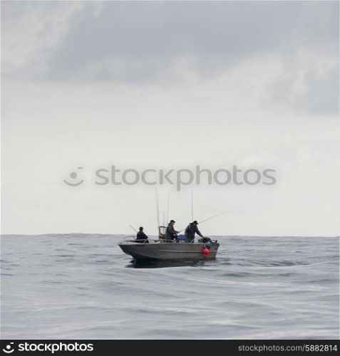 View of fishermen in a boat, Skeena-Queen Charlotte Regional District, Hippa Island, Haida Gwaii, Graham Island, British Columbia, Canada
