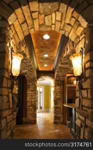 View of foyer through stone archway in affluent home.