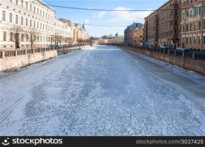 view of frozen Moyka river in Saint Petersburg. view of frozen Moyka river in Saint Petersburg city in March