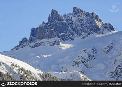 View of Fuerenalp in winter with Spannort Mountain Peaks in background, Engelberg, Canton Obwalden, Switzerland