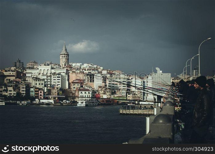 View of Galata Tower ,a medieval stone tower and people fish on Galata tower in Istanbul, Turkey.DECEMBER 24,2016.. View of Galata Tower(Turkish: Galata Kulesi) (Galata Kulesi) Christea Turris is a medieval famous landmark stone tower architecture, in beyoglu, Istanbul.
