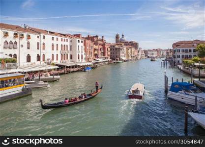 View of Grand Canal with gondolas and colorful facades of old medieval buildings from Rialto Bridge in Venice, Italy.. Grand Canal in Venice
