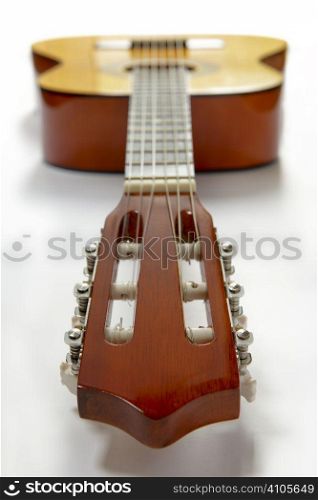 view of guitar from the headstock on white background
