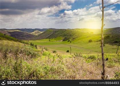 View of hills with clouds and blue sky, Meadow with green hills, Beautiful road leading to a hill