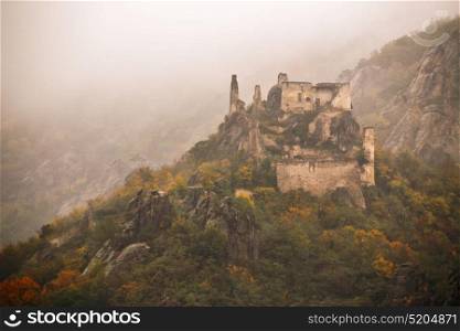 view of historic castle ruin on Danube river, colorful autumn. Wachau valley, Lower Austria region, Austria