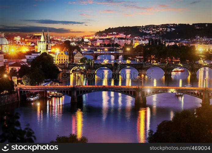 View of illuminated bridges in Prague in evening