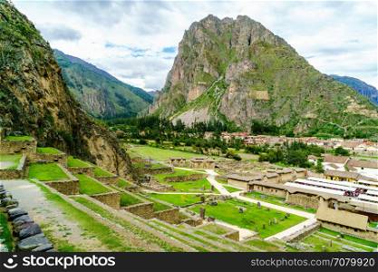 View of inca archaeological site with the Sun Temple on the mountain at Ollantaytambo in Peru