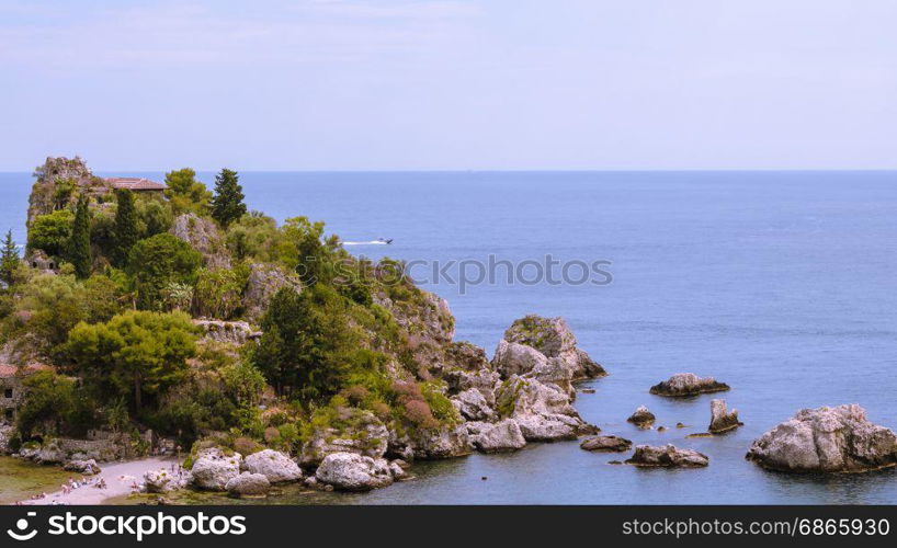 View of island and Isola Bella and blue ocean water in Taormina, Sicily, Italy