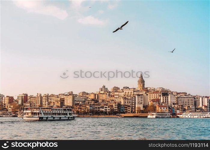 View of Istanbul cityscape Galata Tower with floating tourist boats in Bosphorus ,Istanbul Turkey