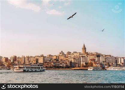 View of Istanbul cityscape Galata Tower with floating tourist boats in Bosphorus ,Istanbul Turkey