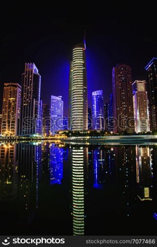 View of Jumeirah Lakes Towers skyscrapers at night. Dubai, UAE.