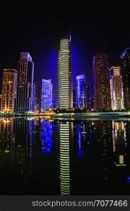View of Jumeirah Lakes Towers skyscrapers at night. Dubai, UAE.