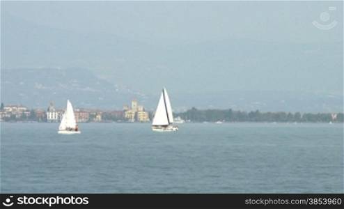 View of Lake Garda between Desenzano and Sirmione with sailing boats