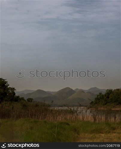 View of lake shore with mountains range in background. Focus and blur.