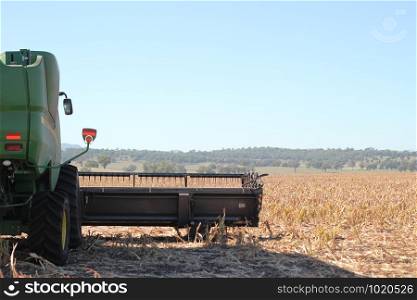 view of large scale farming harvesting equipment in an already harvested field in rural New South Wales, Australia