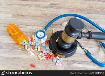 view of law gavel with pills over wooden table, medical law concept. medical law concept