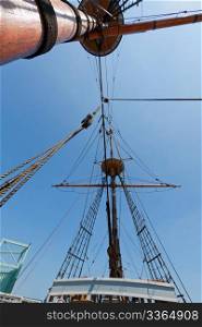 View of mast and rigging on the tall sail ship against the blue sky.