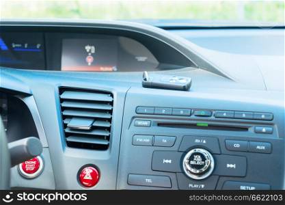 view of modern car dashboard with start power engine and keys. car dashboard with keys