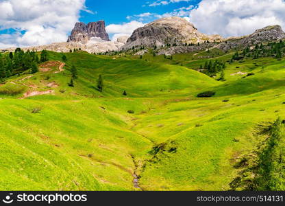 View of Mount Averau in Nuvolau group with the hilly of yellow flowers from the Falzarego Pass at Cortina d?Ampezzo in Italy