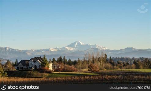 View of Mount Baker from the Fraser Valley with mansion in foreground