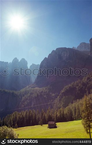 view of mountain Dolomites and the bright sun. Italy.