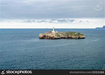 View of Mouro Island (Isla de Mouro), a small uninhabited island with a 19th century lighthouse in the Bay of Biscay, located off the Magdalena Peninsula in the city of Santander, Cantabria, northern Spain