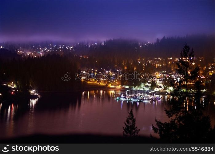 View of night city with lights and blue dramatic sky. North Vancouver, Canada