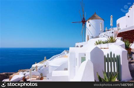 View of Oia town in Santorini island with old whitewashed houses and windmill , Greece -- Greek landscape