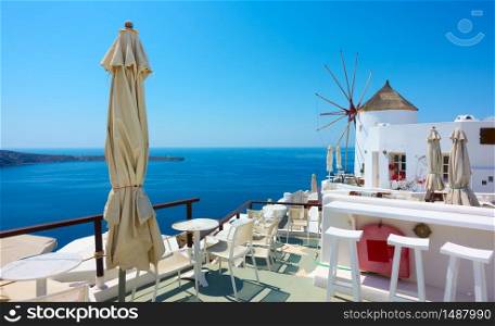 View of Oia town in Santorini island with old whitewashed windmill , Greece -- Greek landscape with space for your own text
