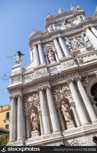 View of old-fashioned facade of historical Palace cathedral in Venice, Italy on a blue sky background.. Palace in renaissance style in Venice, Italy.