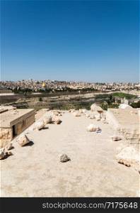 View of Old Jerusalem and Dome of the Rock on the Temple Mount from the Mount of Olives, Israel - selective focus on tombstone. Old Jerusalem Panorama from Mount of Olives