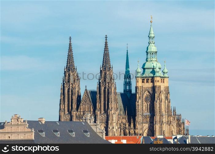 View of old Prague and St. Vitus Cathedral. Red tiled roofs and towers of the old town.. Prague. View of the city from above.