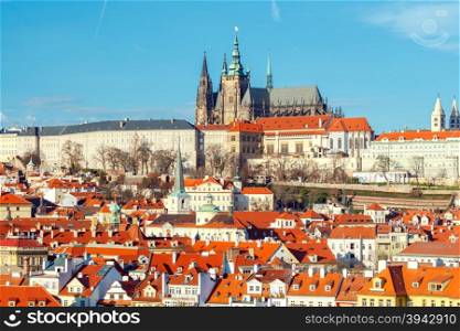 View of old Prague and St. Vitus Cathedral. Red tiled roofs and towers of the old town.. Prague. View of the city from above.