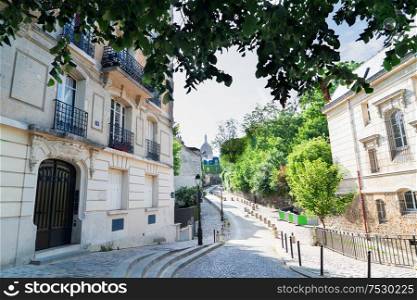 View of old street in quarter Montmartre in Paris, France. Cozy cityscape of Paris with Sacre Coeur church. Architecture and landmarks of Paris.. cityscape Mont Matre , Paris, France