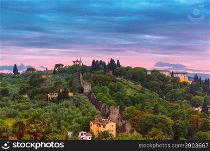 View of Oltrarno, Boboli Gardens, Fortress wall and Forte di Belvedere at sunset from Piazzale Michelangelo in Florence, Tuscany, Italy