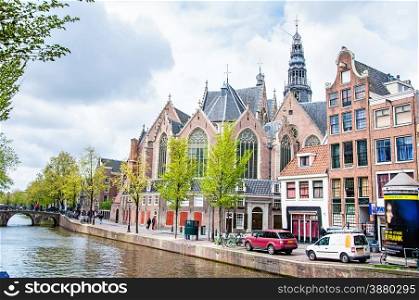 View of Oude Kerk (Old Church) from across the Oudezijds Voorburgwal canal in Amsterdam, Netherlands