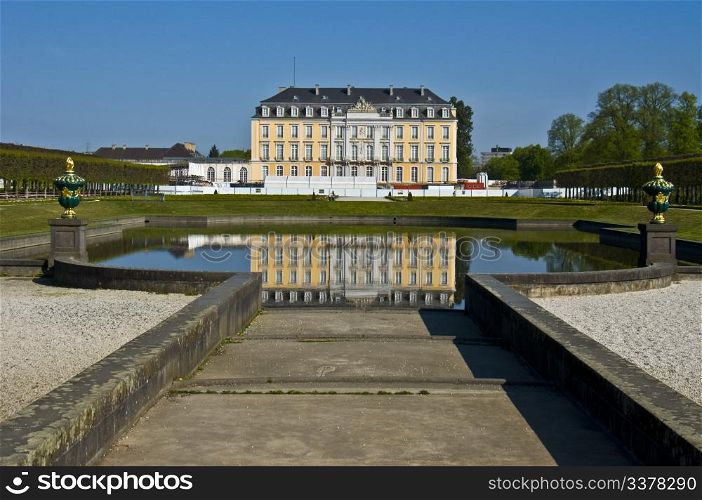 view of palace Augustusburg in Bruehl and the main water pond