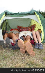 View of people feet from outside a camp tent