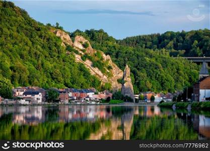 View of picturesque Dinant city over the Meuse river Dinant is a Walloon city and municipality located on the River Meuse, in the Belgian province of Namur on sunset with Bayard Rock and highway. View of picturesque Dinant city. Belgium