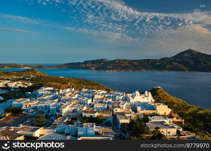 View of Plaka village on Milos island with traditional greek white houses on sunset. Plaka town, Milos island, Greece. View of Plaka village on Milos island on sunset in Greece