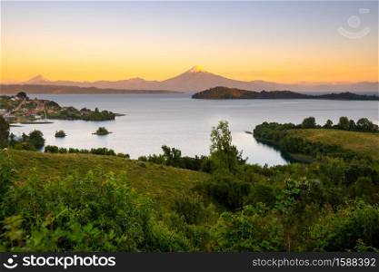 View of Puerto Octay at the shores of Lake Llanquihue, with Osorno Volcano and Puntiagudo Volcano in the back, X Region de Los Lagos, Chile