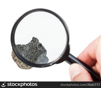 view of raw peridotite stone through magnifier isolated on white background