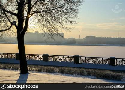 View of Riga from the 11th November Embankment side. Riga view in winter. Frozen river Daugava at the 11th November Embankment.
