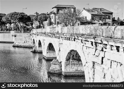 View of Rimini with ancient Bridge of Tiberius (Ponte di Tiberio), Italy - Black and white italian urban view