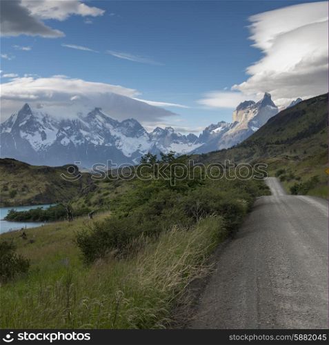 View of road with mountains in the background, Torres del Paine National Park, Patagonia, Chile