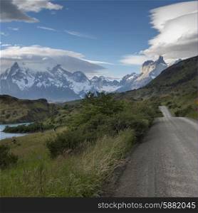 View of road with mountains in the background, Torres del Paine National Park, Patagonia, Chile